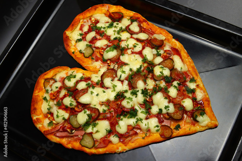 Heart shaped pizza in a baking tray for Valentine's Day