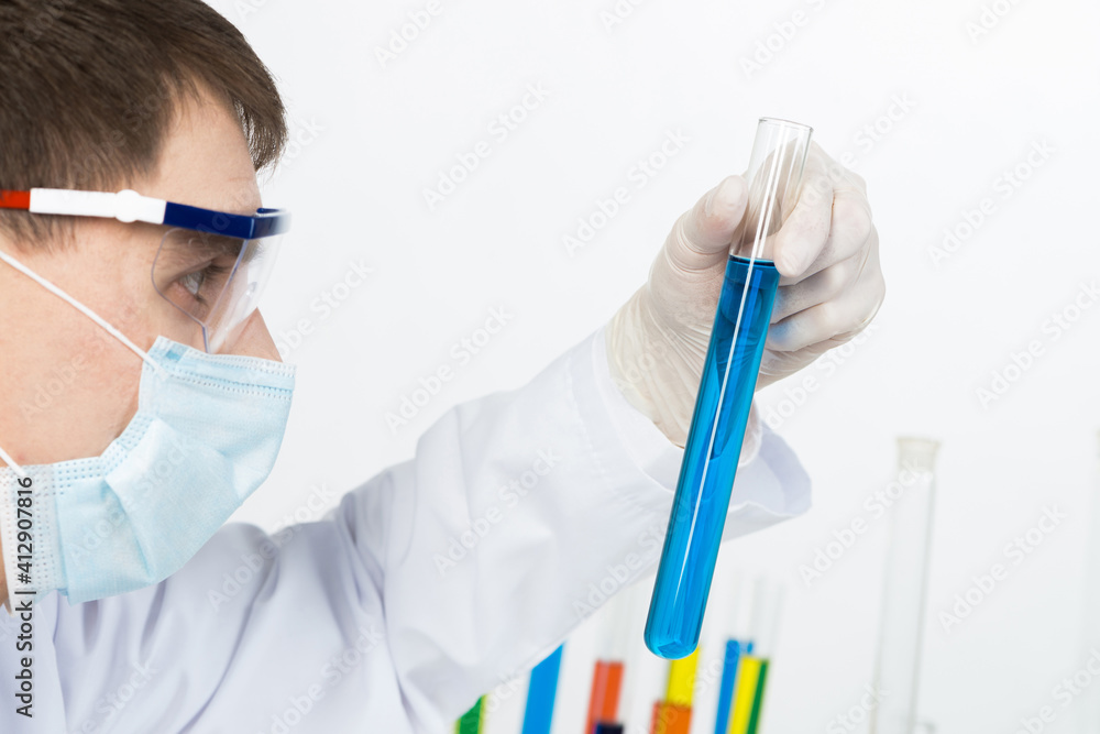 Laboratory technician in safety mask and gloves Laboratory technician in safety mask and gloves