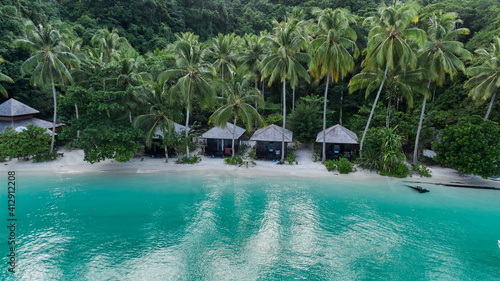 Lagoon With Huts On Ocean Beach In Kaimana Island Raja Ampat. Stunning View From Drone On Turquoise Sea And Picturesque Tropical Resort With Bungalows In Papua, Indonesia. photo