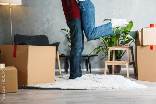 Cropped image of a couple moving together in a new house