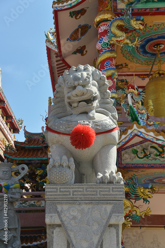 Lion Stone Sculpture at Wihan Thep Sathit Phra Kitthi Chalerm Shrine (Nacha Sa Thai Chue Shrine or Naja Shrine) Bang Sean, Chonburi, Thailand photo