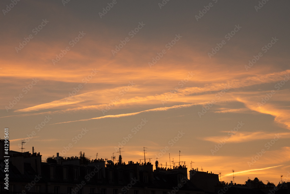 Parisian rooftops silhouettes at beautiful sunset. Paris, France. Urban sunset background.
