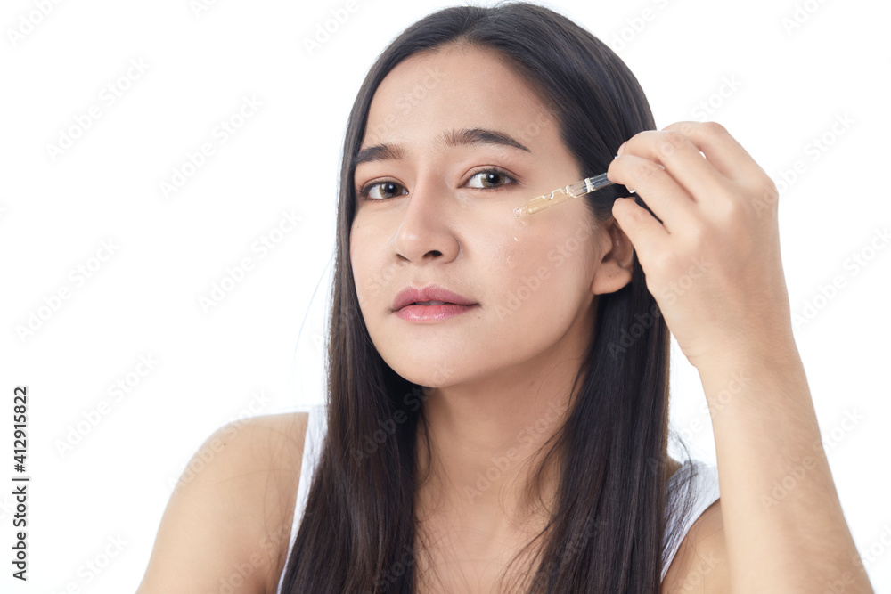 woman holding pipette with a cosmetic oil woman holding pipette with a cosmetic oil