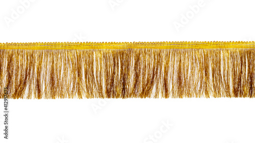 The fringe is golden with a long thin pile. Isolated on white background. Decor, design, decoration, texture.