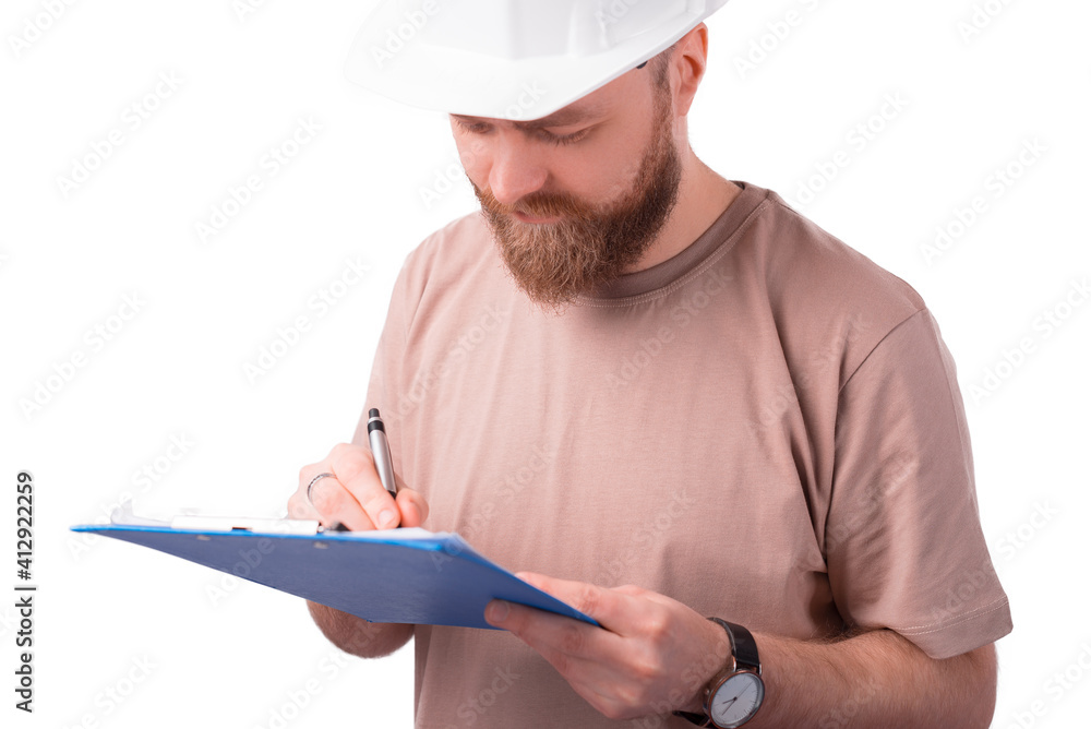Close up portrait of young architect man wearing white helmet and making some notes on paper. Close up portrait of young architect man wearing white helmet and making some notes on paper.