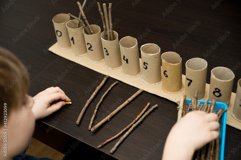 Little child doing simple math exercises. Early education, counting ...