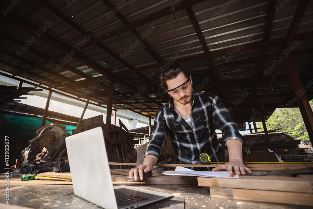 young carpenter caucasian man worker. raftsman profession in wood factory. young carpenter caucasian man worker. raftsman profession in wood factory.