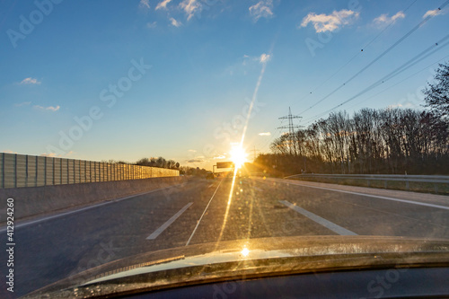 german highway in sunset with driving cars