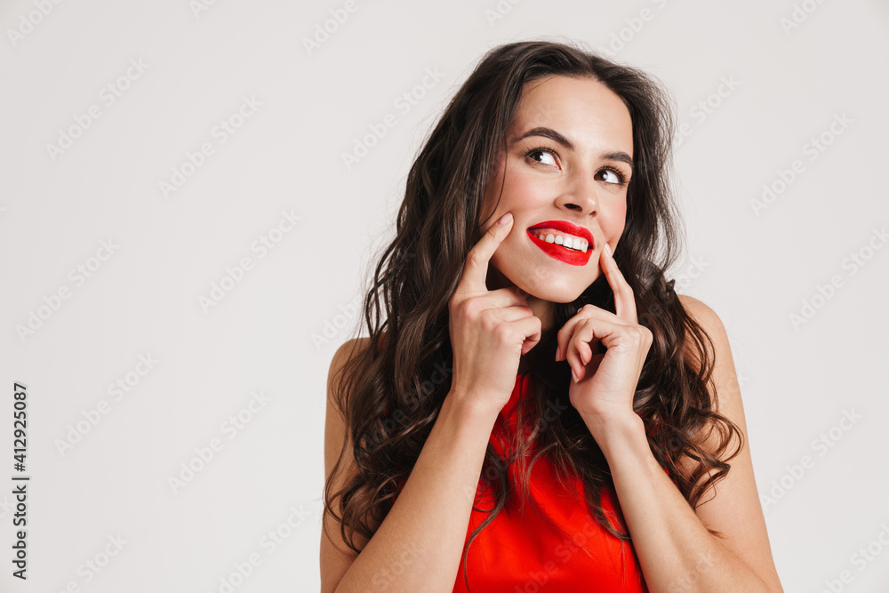 Happy beautiful girl smiling and pointing fingers at her cheeks Happy beautiful girl smiling and pointing fingers at her cheeks