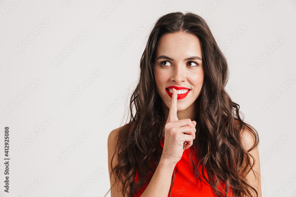 Happy beautiful girl smiling and showing silence gesture Happy beautiful girl smiling and showing silence gesture