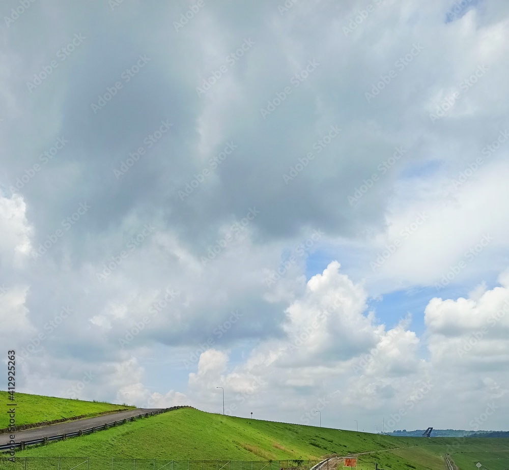 Fototapeta premium field and blue sky with clouds