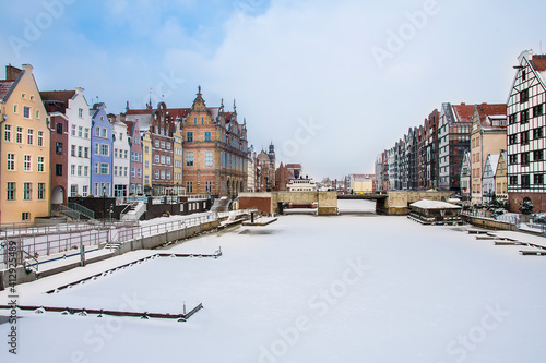 Colorful tenement houses and the frozen Motlawa river in Gdansk, Poland 