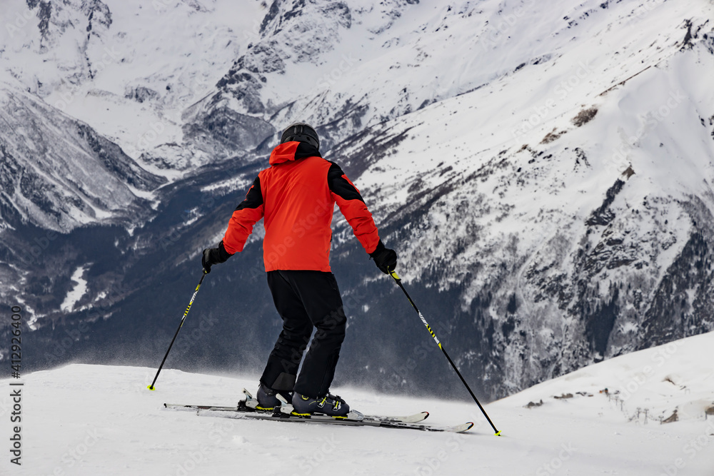 Skier prepare to descend alpine slopes. Winter sports and recreation. Skier prepare to descend alpine slopes. Winter sports and recreation.