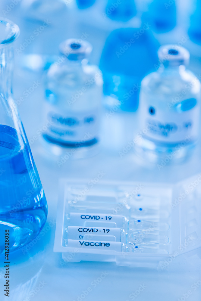 Bottle of COVOD-19 vaccine sample in a laboratory. Idea for researching and lab tests for coronavirus curing.