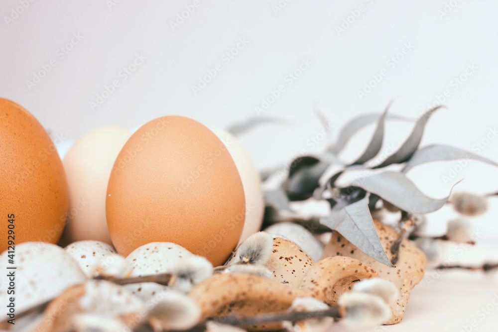 Easter unpainted chicken eggs in a ceramic egg holder. Dried flowers, beige color, place for text Easter unpainted chicken eggs in a ceramic egg holder. Dried flowers, beige color, place for text