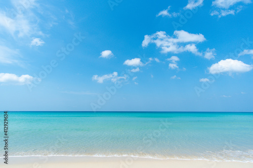 White beach sand Sea water blue Blue sky clear background © BUDDEE
