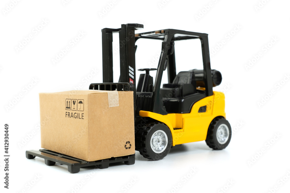 Mini forklift truck loading box on white background. online shopping concept Mini forklift truck loading box on white background. online shopping concept