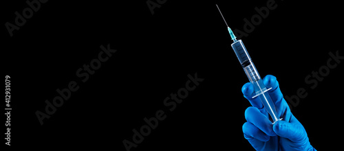 Fototapeta Naklejka Na Ścianę i Meble -  Hand holding syringe with vaccine against corona virus.