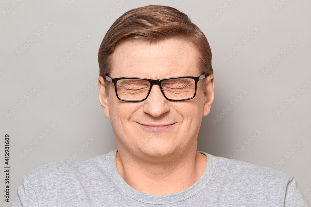 Portrait of happy man dreaming about something with eyes closed Portrait of happy man dreaming about something with eyes closed