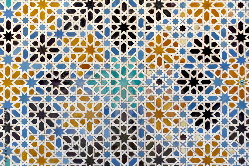 Obraz premium Moorish glazed tiles mosaic pattern in the Alcazar palace of Seville, Spain