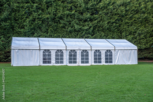 Large white marquee tent on lawn