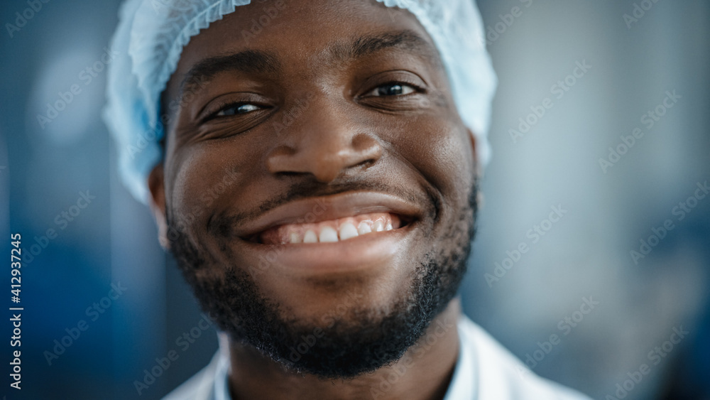 Close Up Portrait of a Black African American Handsome Male in a Light Blue Casual Shirt. Successful Man Calmly Smiles while Looking at Camera. Happy Stylish Businessman or a Doctor in Hospital. Close Up Portrait of a Black African American Handsome Male in a Light Blue Casual Shirt. Successful Man Calmly Smiles while Looking at Camera. Happy Stylish Businessman or a Doctor in Hospital.