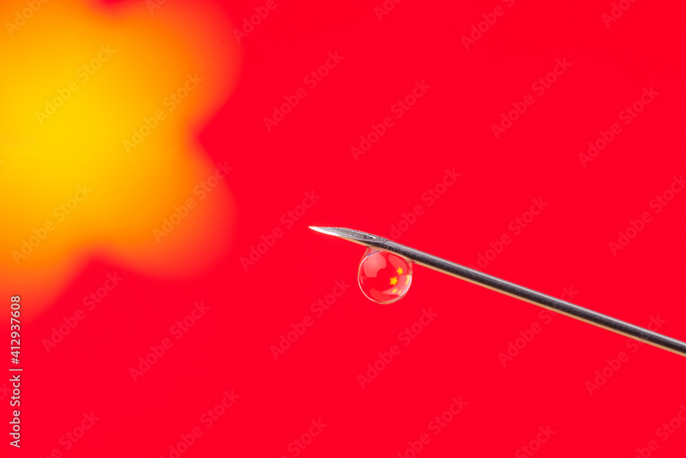 Vaccination in China. Needle with a small drop against flag of China in the background. Vaccination in China. Needle with a small drop against flag of China in the background.