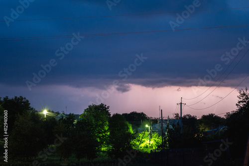 Summer night thunderstorm in the village. Distant lightning