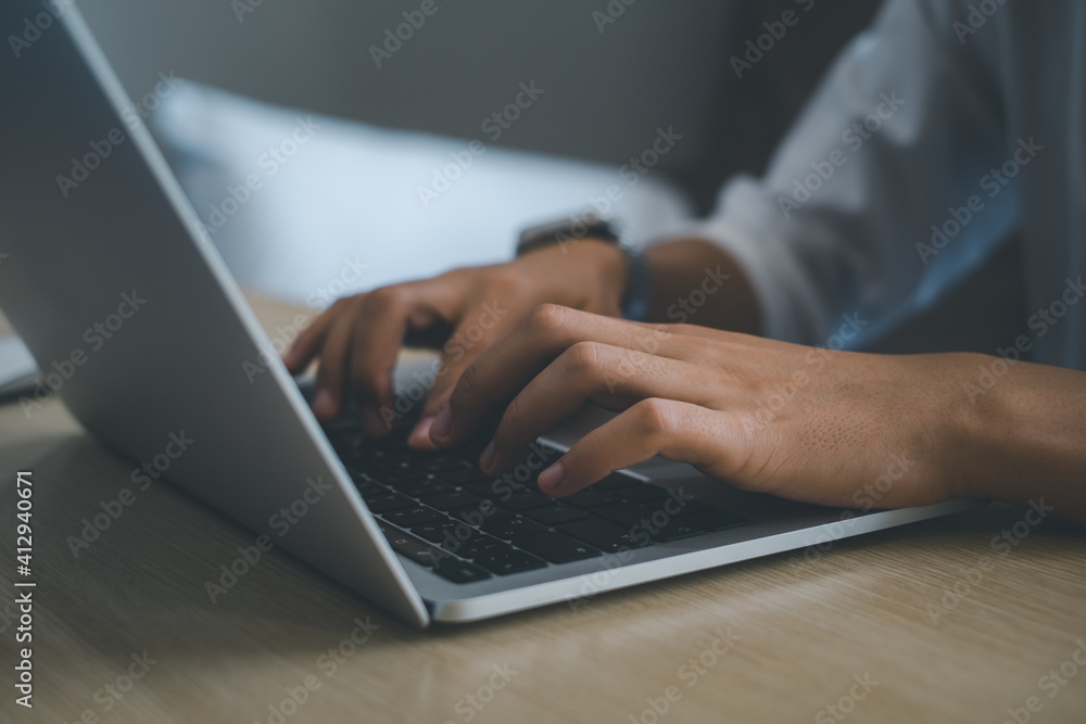 Businessman or student wearing white shirt using laptop for searching, working, online learning, marketing, freelance, studying, distance education network online technology background. Businessman or student wearing white shirt using laptop for searching, working, online learning, marketing, freelance, studying, distance education network online technology background.