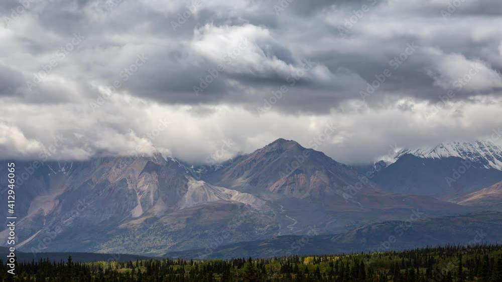 Canadian Rocky Mountain Landscape during a cloudy and sunny day in Fall Season. View from Alaska Highway in Yukon, Canada. Time Lapse Canadian Rocky Mountain Landscape during a cloudy and sunny day in Fall Season. View from Alaska Highway in Yukon, Canada. Time Lapse