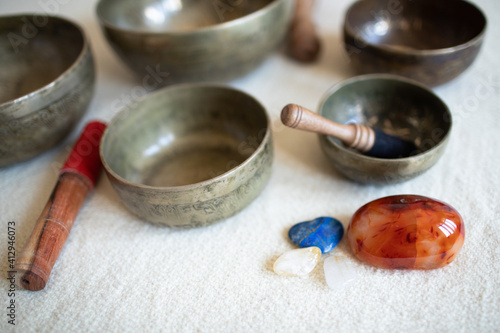 Singing bowls or Tibetan bowls and wooden mallet or stick for meditation, mindfulness, sound healing, relaxation. With crystals (lapis lazuli, carnelian, citrine and calcite)