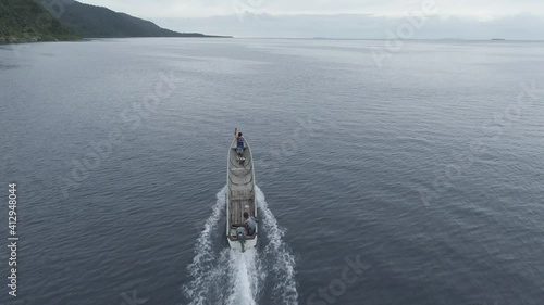 Aerial View Of Boat Splashing Water In Triton Bay In Kaimana Islands. Wide Angle Shot Of Ocean With Watercraft In Papua, Indonesia. photo