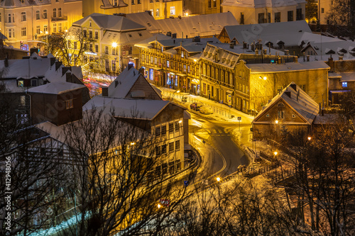 View of the illuminated, snow-covered old town in Oliwa. Gdansk, Poland.