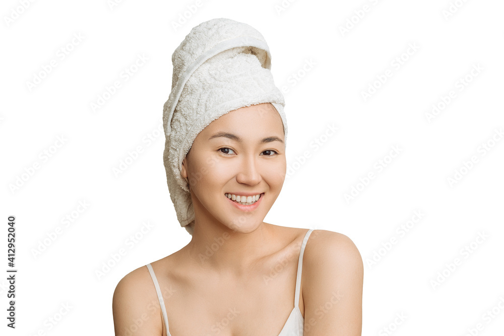 young attractive Asian woman with a towel on her head after bath procedures on a white isolated background. the concept of body care, health and youth young attractive Asian woman with a towel on her head after bath procedures on a white isolated background. the concept of body care, health and youth