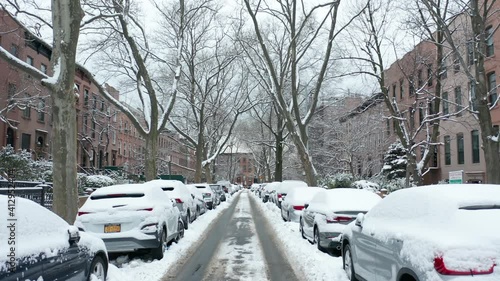 tracking forwards on snow covered Second Place in Carroll Gardens Brooklyn photo