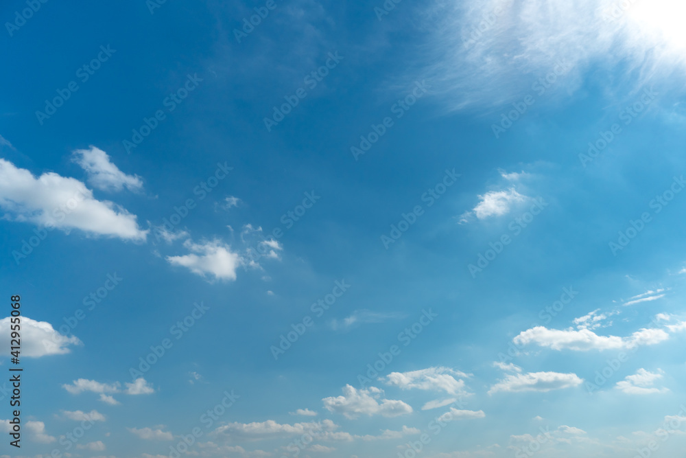 Beautiful fluffy clouds in the evening sky. The sunlight gives a side light on the clouds. Clouds before rain.