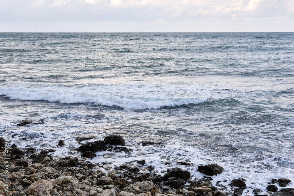 Fototapeta premium stony coast of the winter sea on a cloudy day