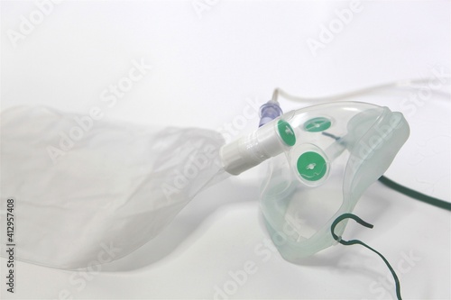 Isolated medical equipment oxygen breathing mask for respiratory support of sick patients at hospital cure covid on wooden neutral background to use by doctors and nurses at clinic
