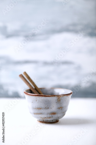 Traditional, handcrafted ceramic on bright wooden background. Copy space.	