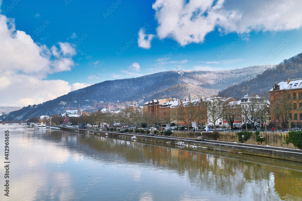 Heidelberg, Germany.  View on Odenwald forest hill with historical castle and neckar river. View from Theodor Heuss bridge on sunny winter day with snow