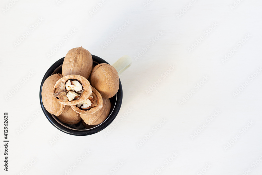 Walnuts in a mug on a white background. Close up Walnuts in a mug on a white background. Close up