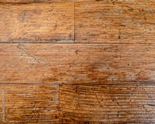 weathered natural wooden planks pattern closeup, brown background