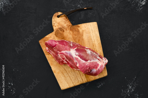 Canvas Print Overhead view of raw lamb rump on cutting board