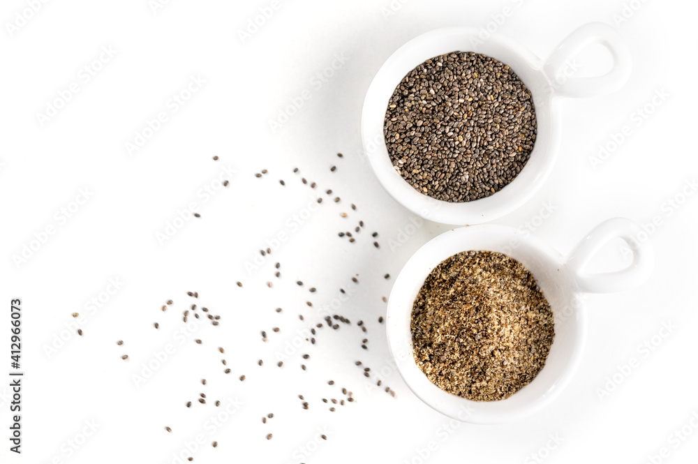 Crushed chia seeds in a ceramic bowl on a white background close-up. Replacing eggs in cooking. Flax egg. Crushed chia seeds in a ceramic bowl on a white background close-up. Replacing eggs in cooking. Flax egg.