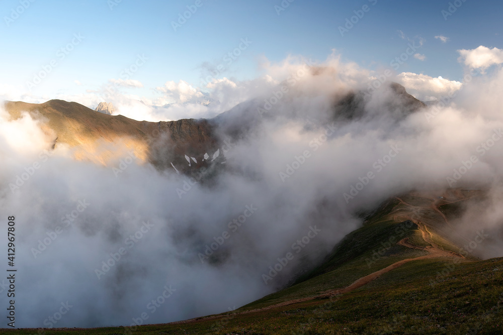mountain gorge Mukhinskoe under a layer of low clouds. Teberda, Russia