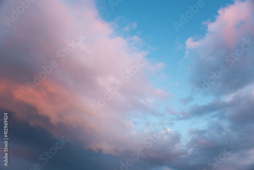 closeup to evening sunset background with pink clouds and blue sky
