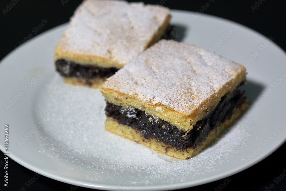 two pieces of the poppy seed cake on the white plate two pieces of the poppy seed cake on the white plate