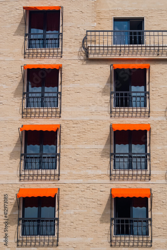 Classic Rectangular Window With Wrought Iron In European Style With Orange Awnings