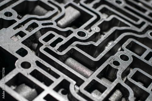 Close up automatic transmission control center variator gearbox valve body on black background