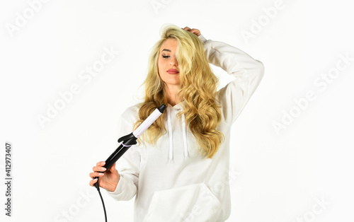 Love is in the hair. Fashion and beauty. Stylist curling hairdo. fashion model woman. Beautiful blonde woman. Girl With Gorgeous Healthy Smooth Hair Using Curler For Perfect Curls